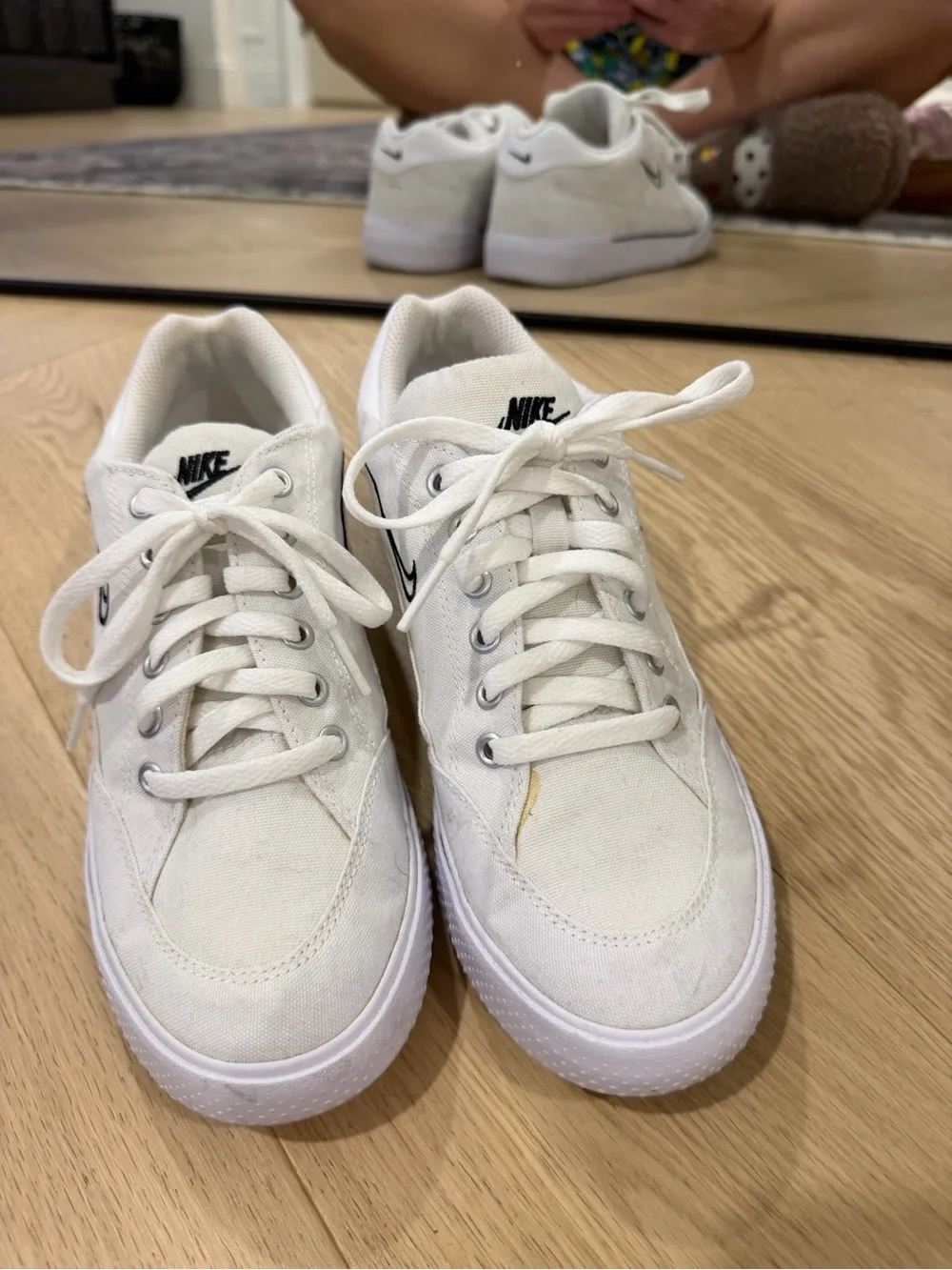 Nike Women’s White Canvas Sneakers with Black Swoosh